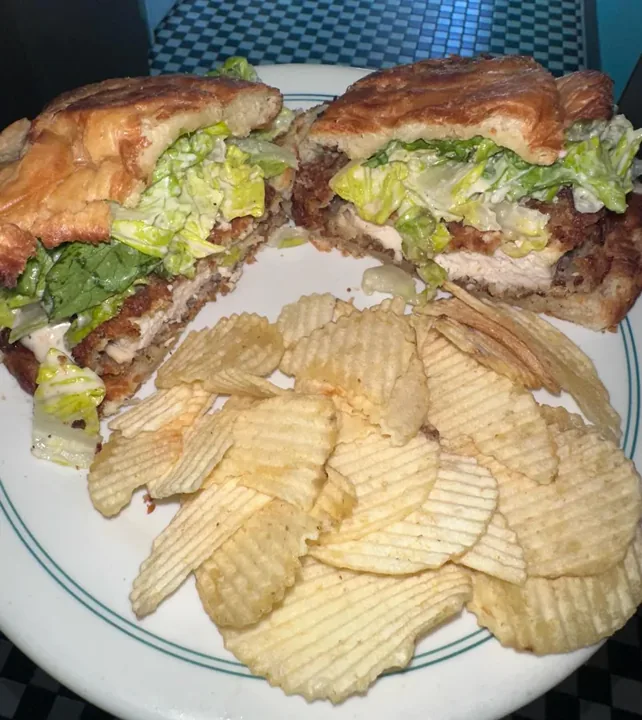 Chicken Caesar salad croissant with chips