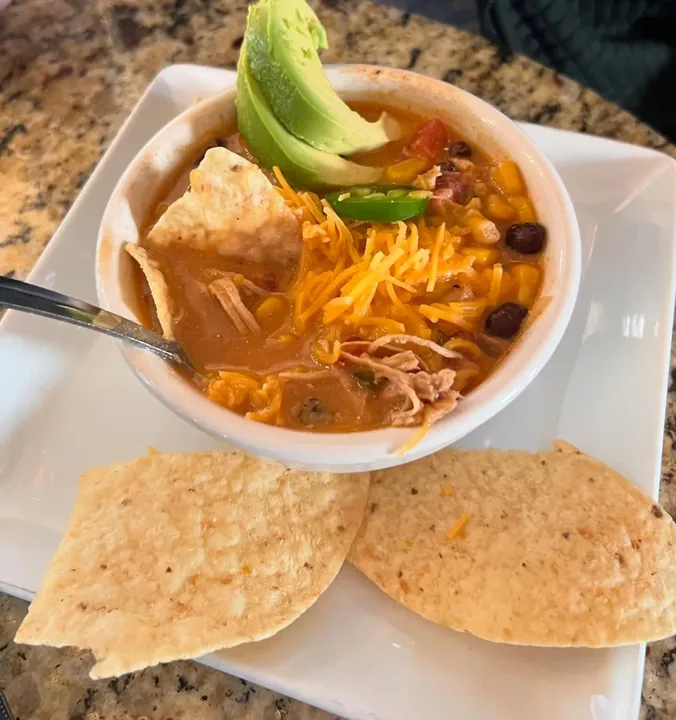 Chicken tortilla soup with avocado and chips